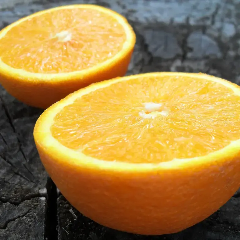 oranges-sliced-in-half-on-wood