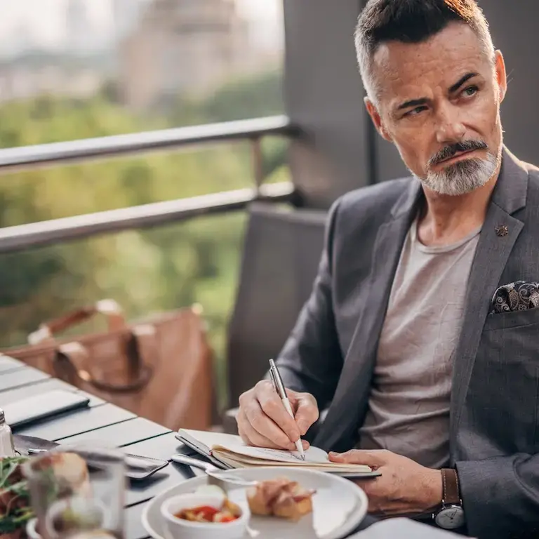 Man taking notes about meal as gastronomical critic