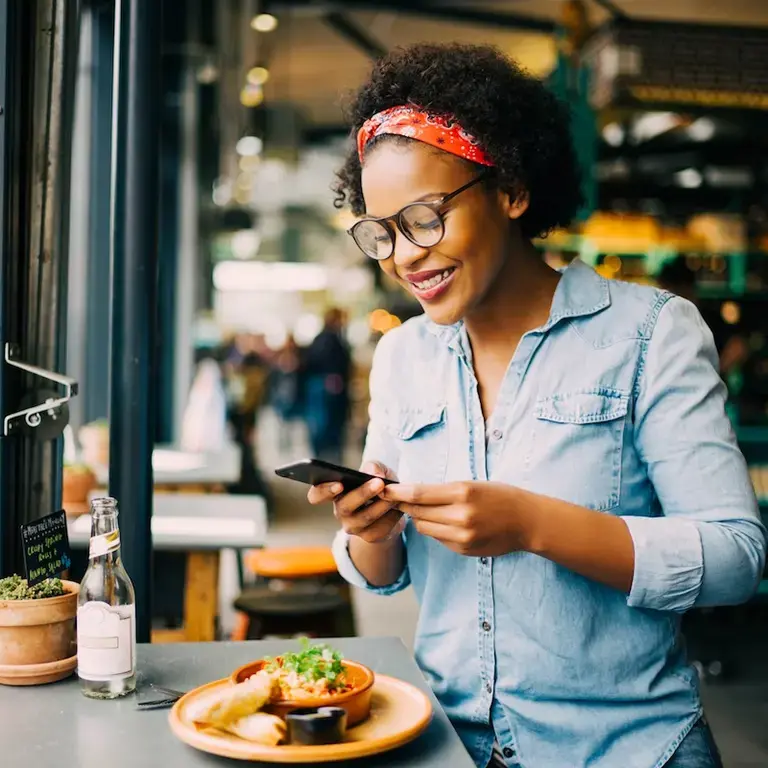 Girl taking meal picture and scrolling mindlessly phone