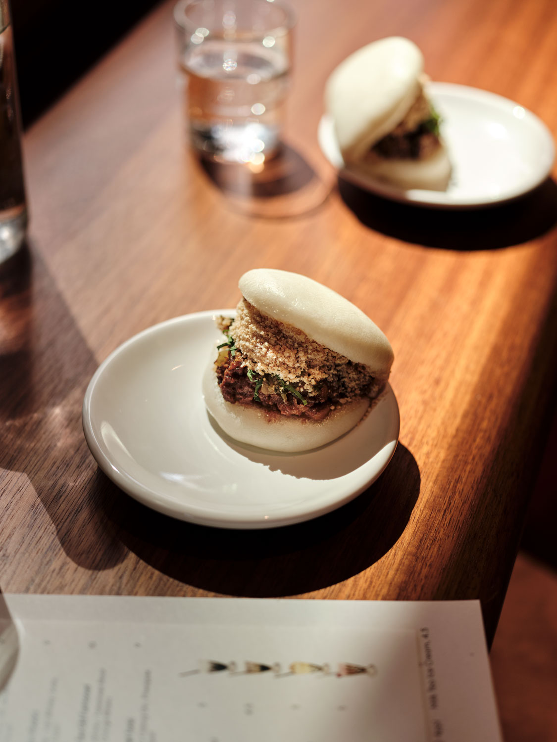 Two bao buns on a table