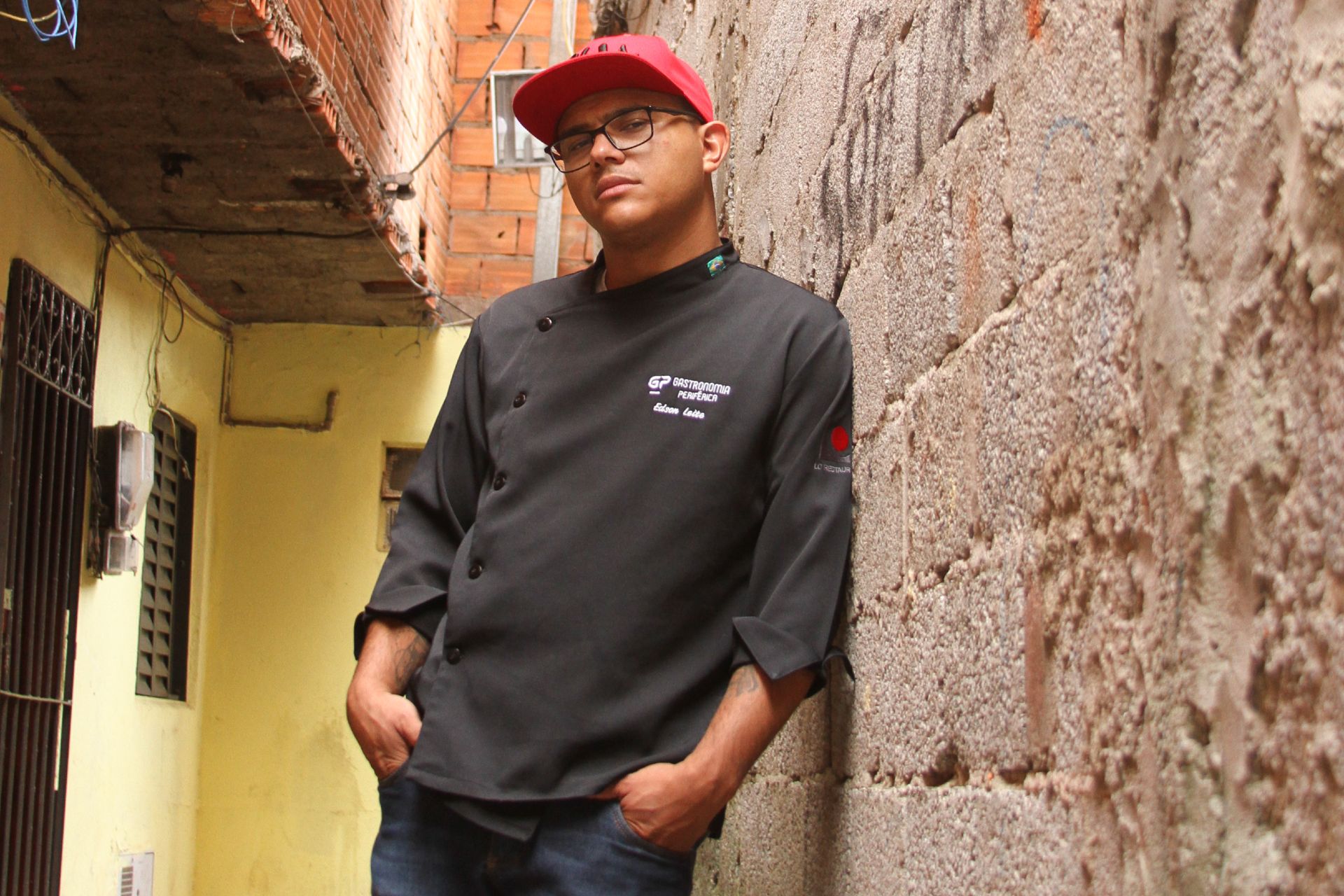 chef Edson Leite leaning against a wall