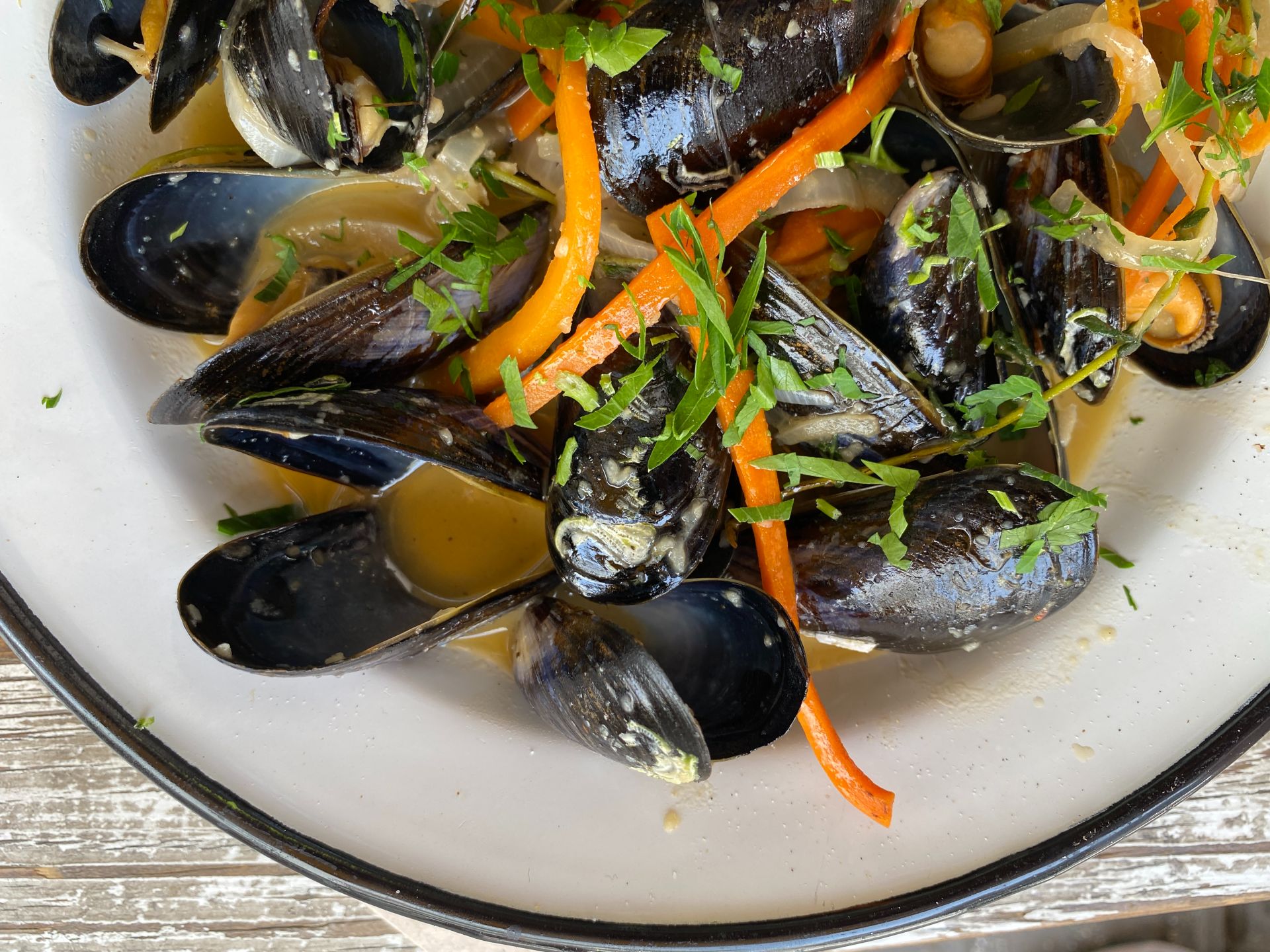 a dish of mussels in ouzo